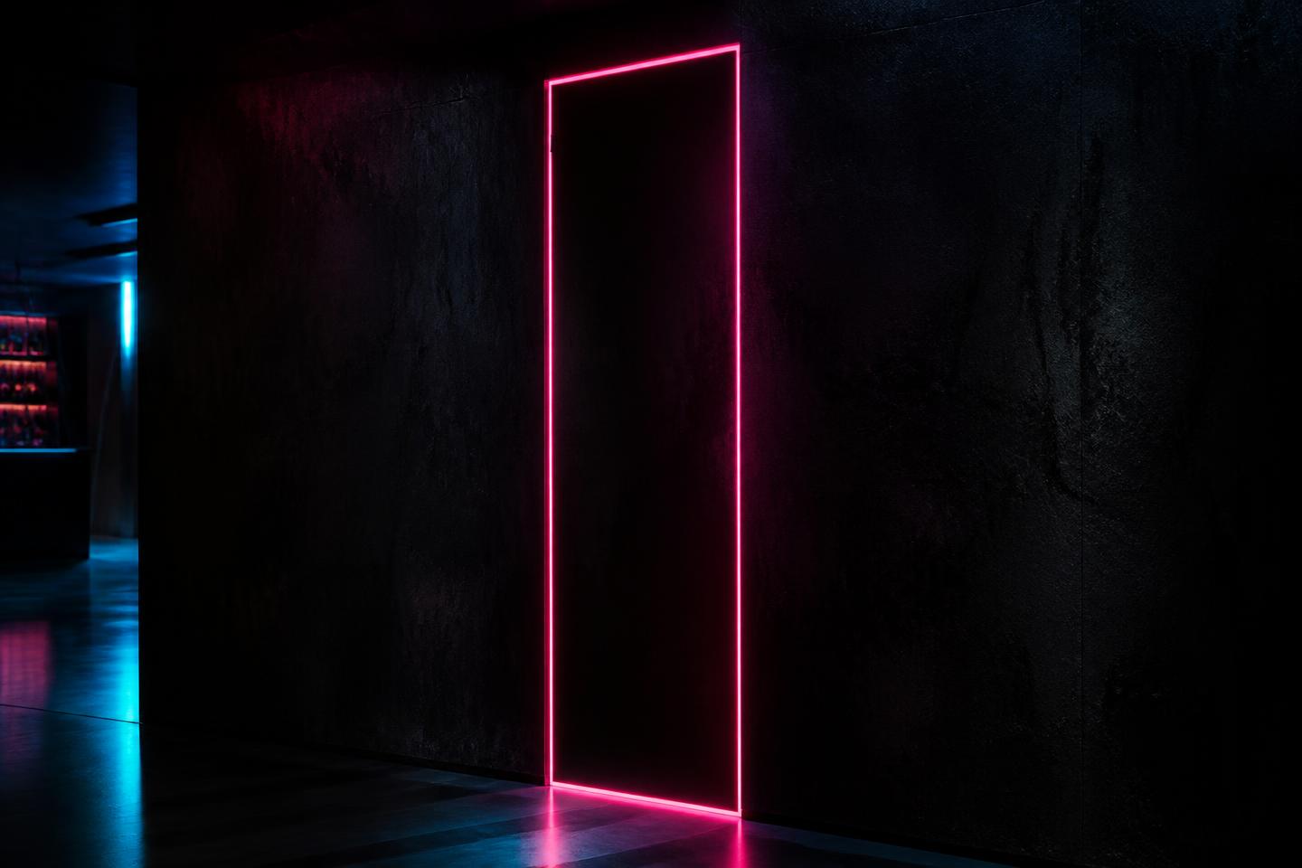 A hidden door in a black wall outlined by neon pink light